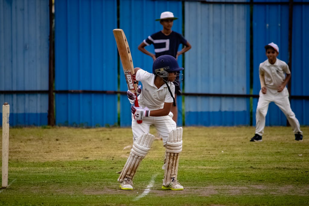 Playing 11 today young cricketer prepares to bat during a match in Gahunje, India.