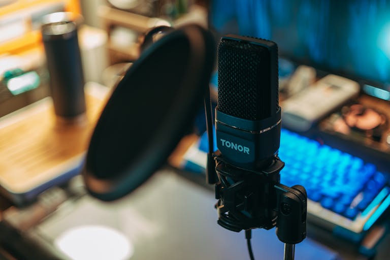 Live streaming free of a modern studio microphone with pop filter on a desk, perfect for recording.