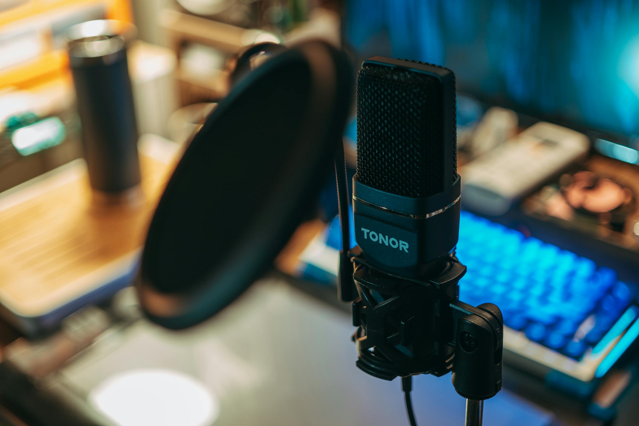 Live streaming free of a modern studio microphone with pop filter on a desk, perfect for recording.