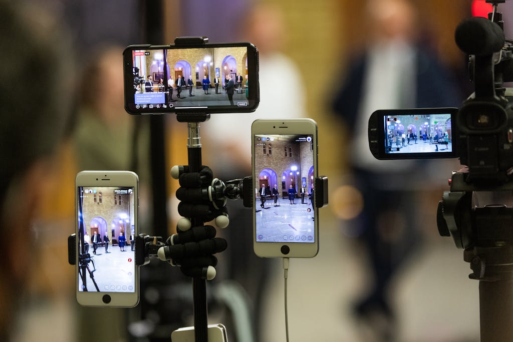 Multiple Live streaming free phones capturing a live event at a prominent landmark in Oslo, Norway.